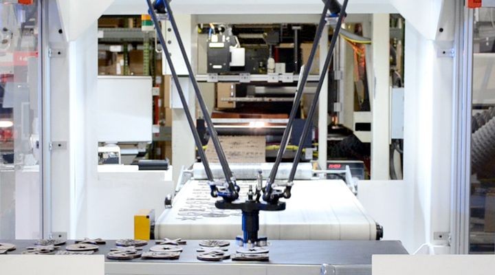 Robot arm picking up abrasive discs